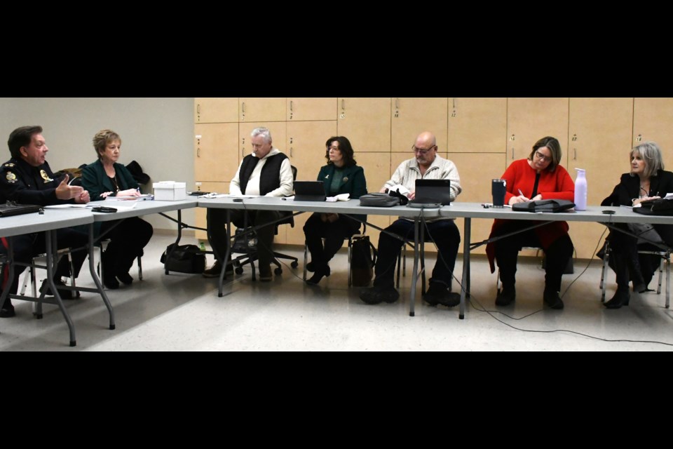 Members of the police board listen to Chief Rick Bourassa (left) during a recent meeting. Photo by Jason G. Antonio