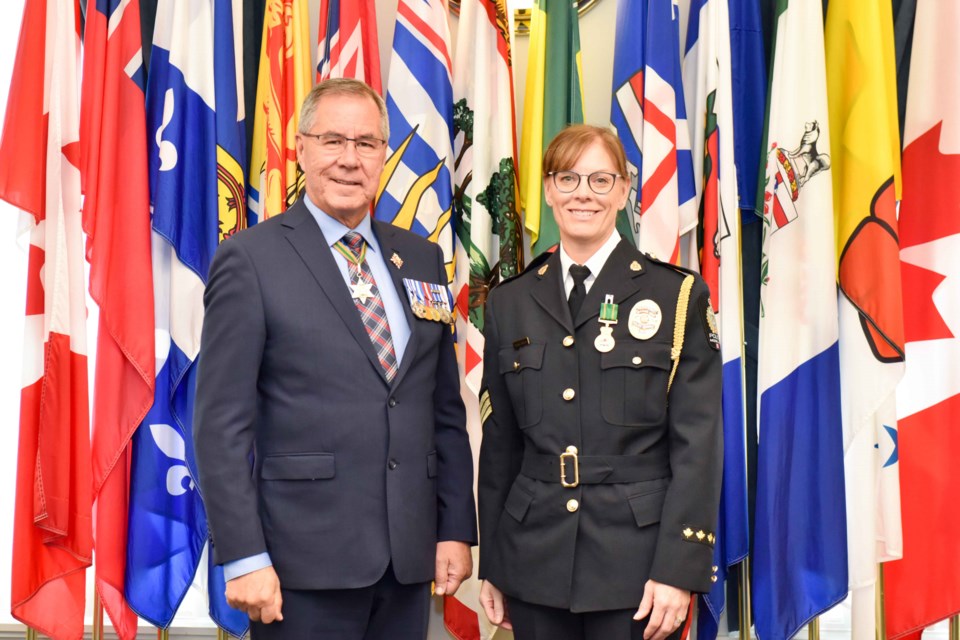 Saskatchewan Lieutenant Governor Rick Mirasty alongside Staff Sergeant Trish Seman during the bestowment of a Saskatchewan Protective Service medal for long-standing service in MJPS