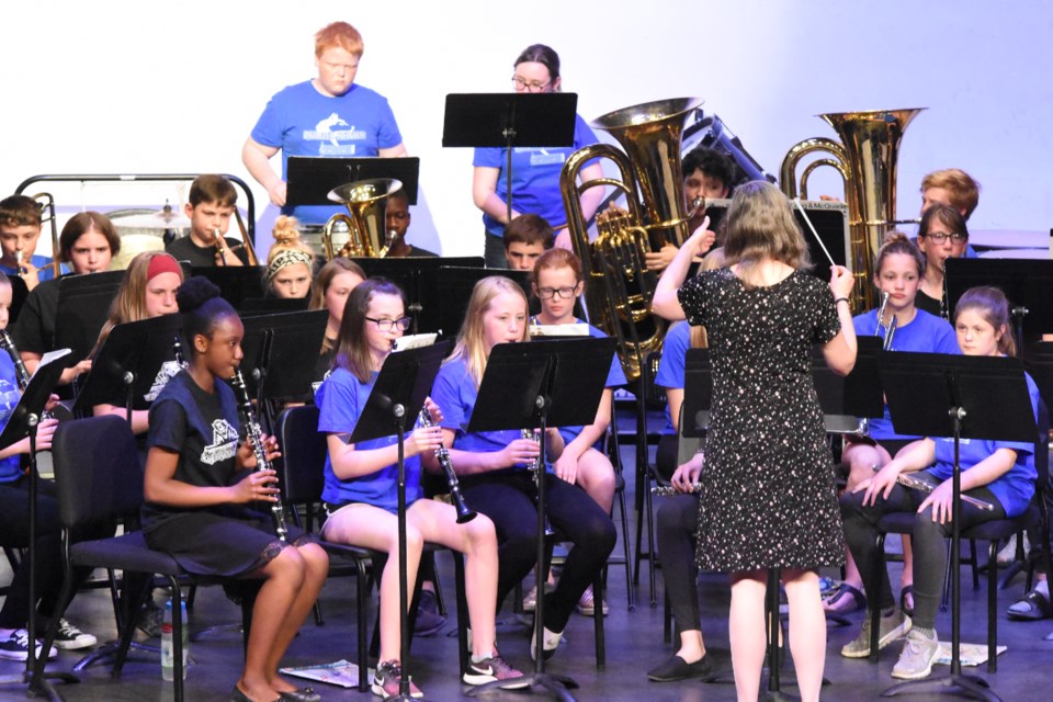 Led by Jennifer Tenford, the Prairie South combined Grade 7/8 band performs several melodies from the movie “Jurassic Park,” during a fundraising concert for the Peacock Centennial Auditorium, on June 4 at A.E. Peacock. Photo by Jason G. Antonio