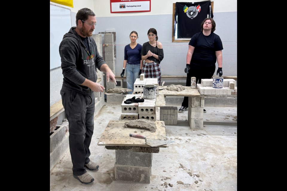 John Walker, instructor and training co-ordinator with the bricklayers union, explains how the bricklaying trade works. Photo courtesy Christa Lapointe