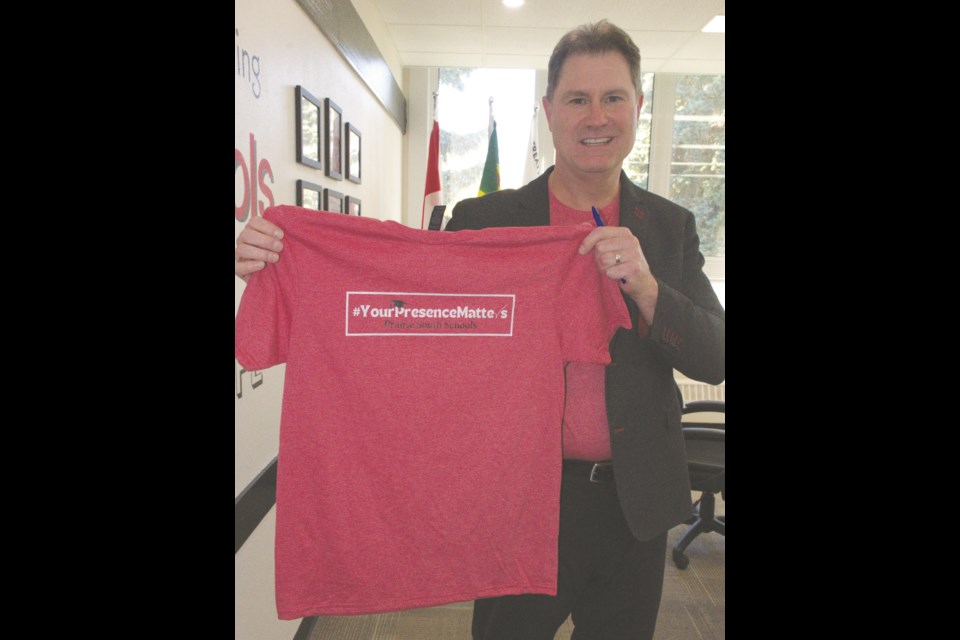 Ryan Boughen, education director for Prairie 鶹ýAV School Division, holds a T-shirt promoting the organization's attendance matters-focused campaign. Photo by Jason G. Antonio