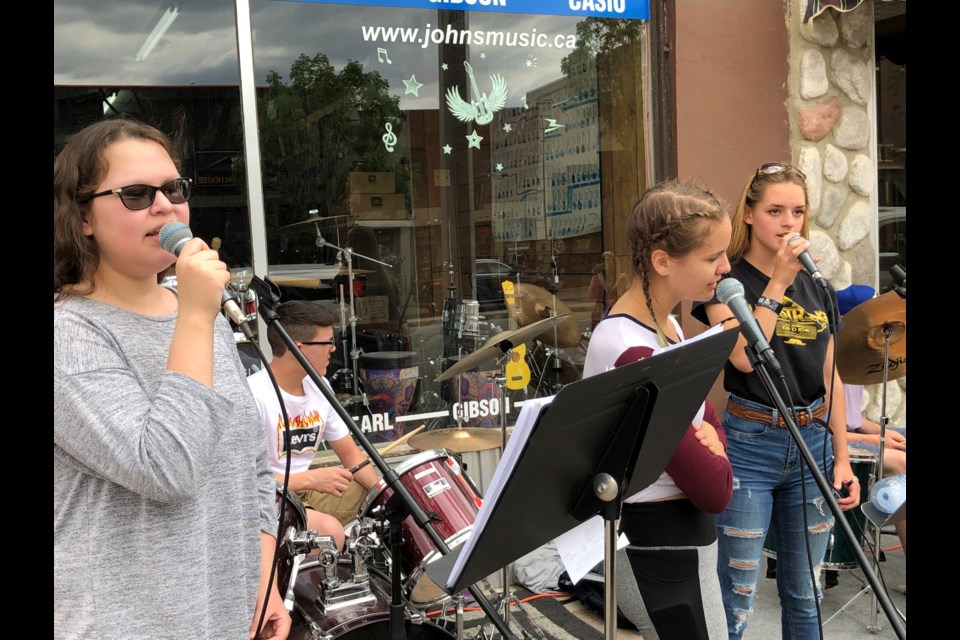 Ayreon Beaudin, Josie Monsees and Kirsten Hunter provide vocals on Bryan Adams' "Summer of '69" while performing with their Rock Band classmates. Photo by Jason G. Antonio 