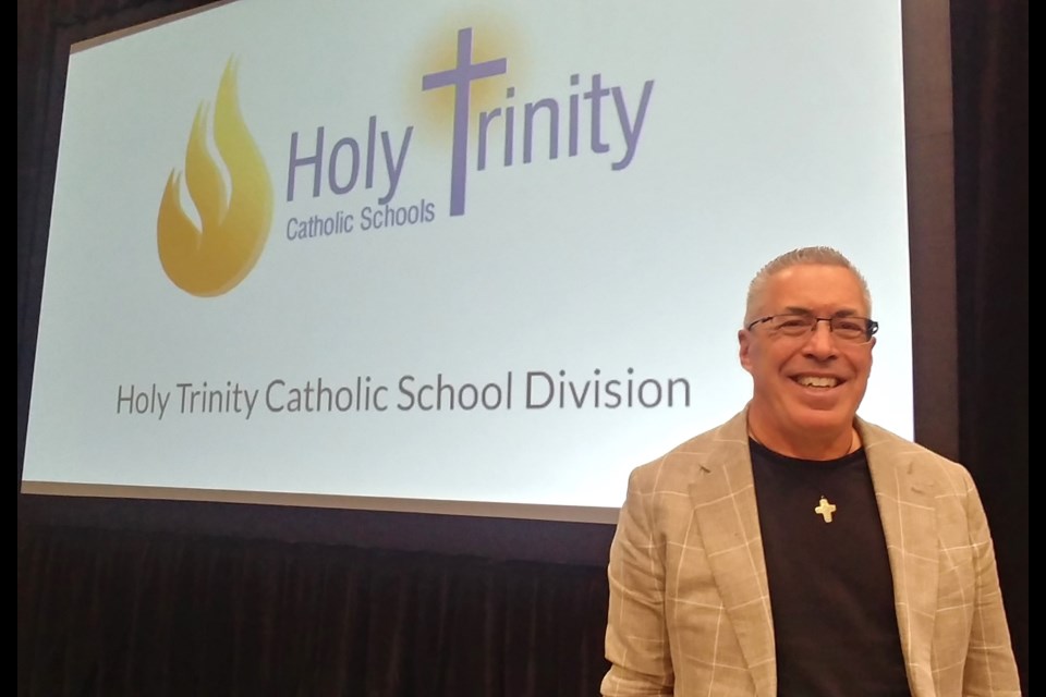 Steve Angrisano, a Dallas, Texas-based singer, songwriter and storyteller, speaks to staff from Holy Trinity Catholic School Division during the division's opening faith day. Photo by Jason G. Antonio