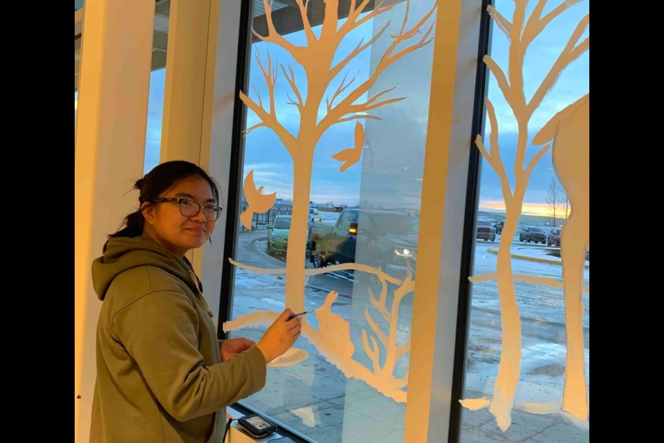 Sean, a student volunteer from Mrs. Kammer's Art 20 class, works on some finishing touches on the hospital's new mural on or around Dec. 6.