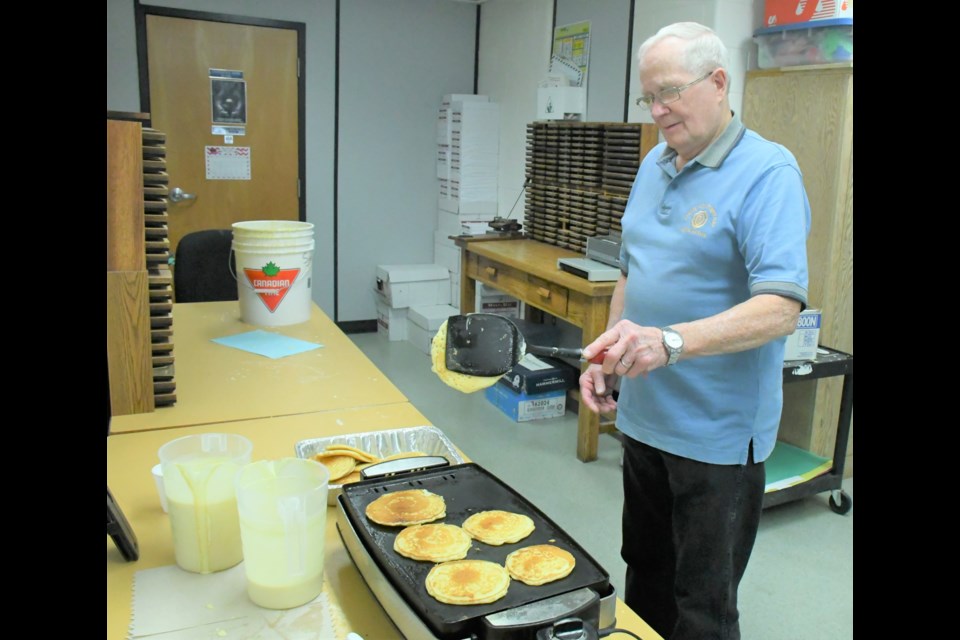 Keith McCaig with The Friendly City Optimists of Moose Jaw whips up pancakes in preparation for the breakfast at Westmount School on Feb. 26. Photo by Jason G. Antonio 