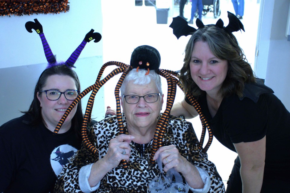 Chateau St. Michael’s staff and one resident (centre) take a pause during the Halloween carnival for a photo on Oct. 26. Krista Bakken, the home’s activity co-ordinator, is on the right.