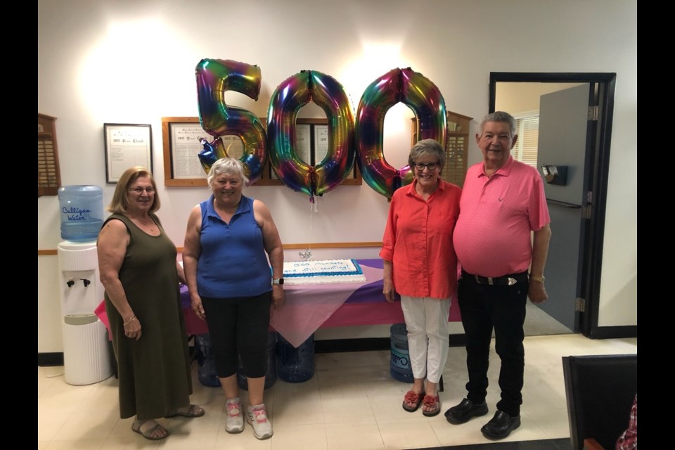 The Moose Jaw & District Seniors Association board members stand for a picture with the cake celebrating their recent 500-member milestone on June 12, 2023