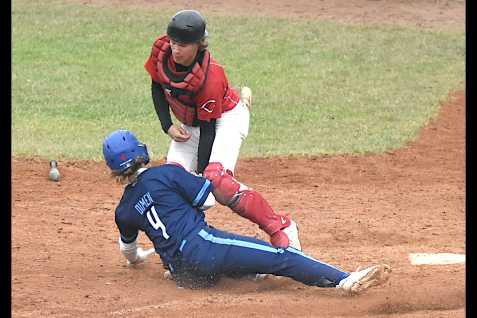 Canucks catcher Noah Thul tags out Saskatoon baserunner Kaden Dimen at home.