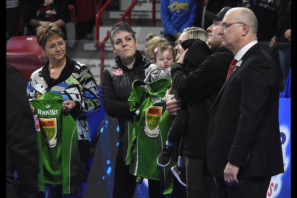 Members of the Sherry Anderson rink and Scott Jenkins are presented with Team Saskatchewan jackets during the memorial ceremony.