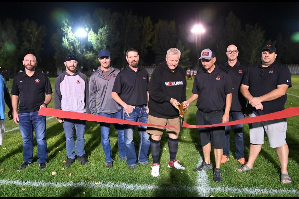 Mayor Clive Tolley cuts the ribbon officially commemorating the grand opening of the Kinsmen Sports Complex and Elks Field.