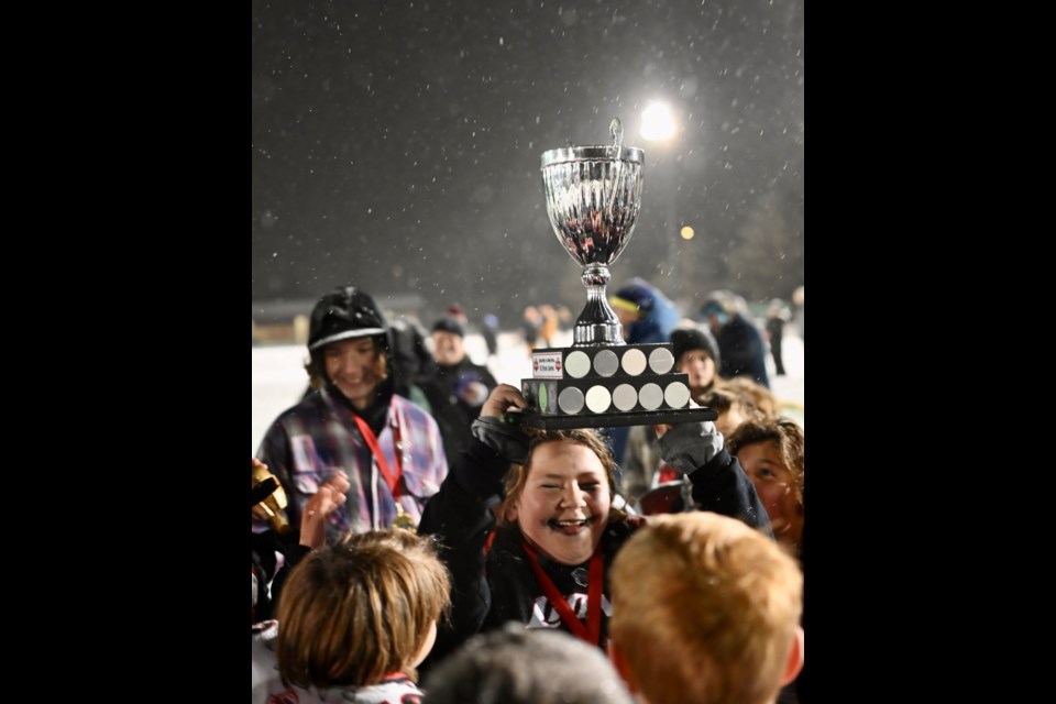 Despite the falling snow Moose Jaw Lion's players were each given the opportunity to individually hoist the U12 league championship trophy