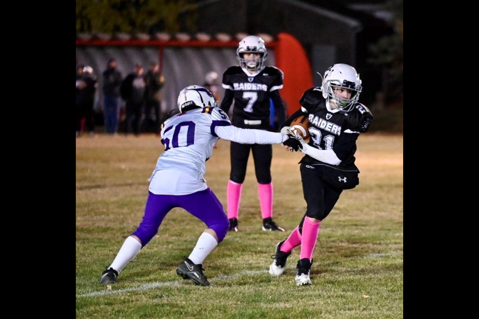 Moose Jaw Vikings Kallen Berber (left) tries to corral Moose Jaw Raiders Nathan Seman.