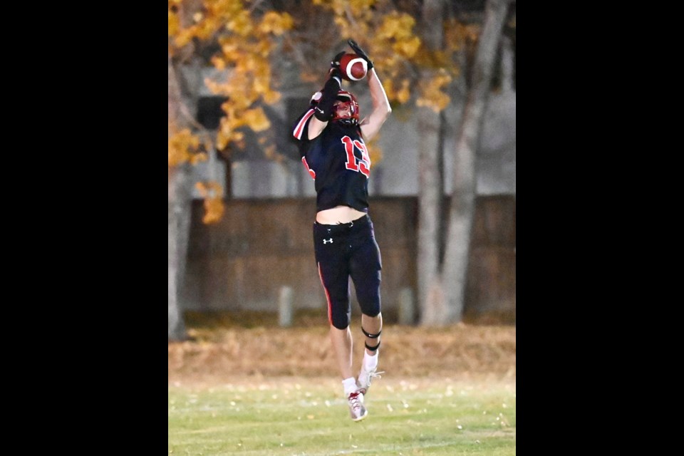 Vanier Vikings Zayden Anderson jumps to make a catch behind cover and then off to the end zone.