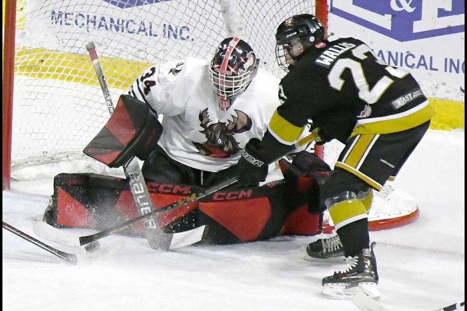 Warriors goaltender Luke McKechnie makes a stop in close on the Bears’ Talen Wallis on his way to his 37-save shutout.
