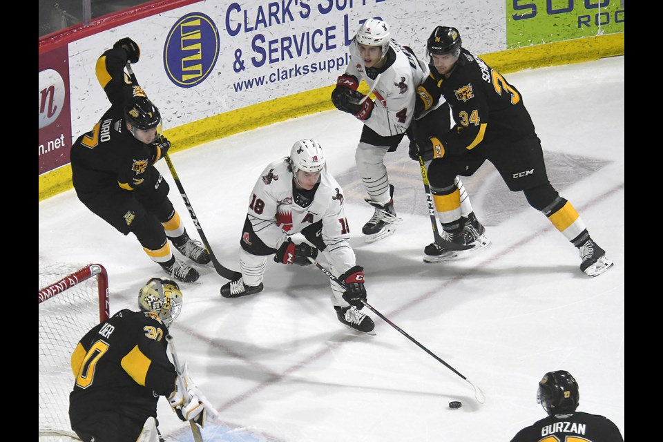 Moose Jaw Warriors forward Tate Popple looks to get a shot off at the side of the Brandon net.