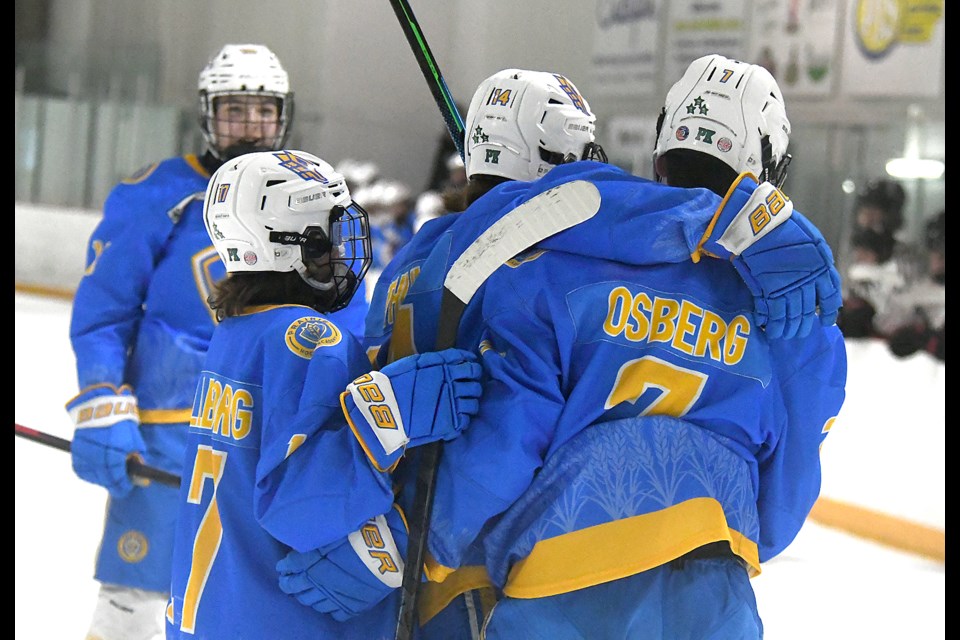 Kierin Osberg celebrates his first period goal with his Cougars teammates on Saturday night.