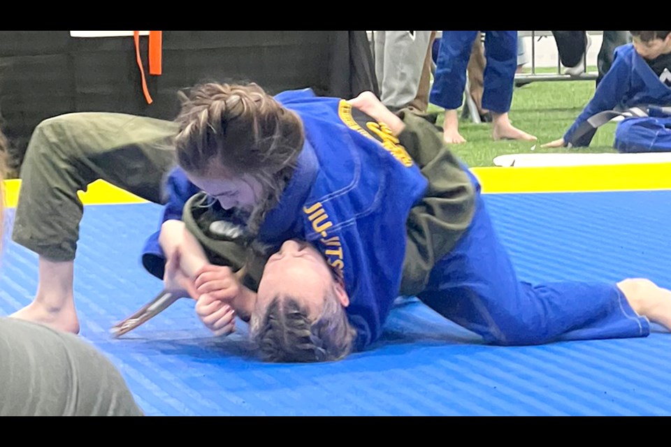 Control Jiu Jitsu’s Payton Pinel works on an americana submission in the girls 9-10 years featherweight division.