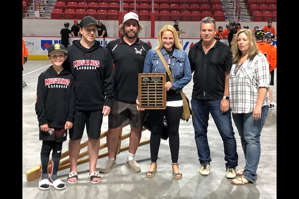 Moose Jaw Lacrosse Association past president Bobbi Ingalls accepts the MJLAX Builder Award as fellow long-time local lacrosse supporters Cody Nidesh, Derek Burns, Barry Stewart and Carrie Johnson look on.