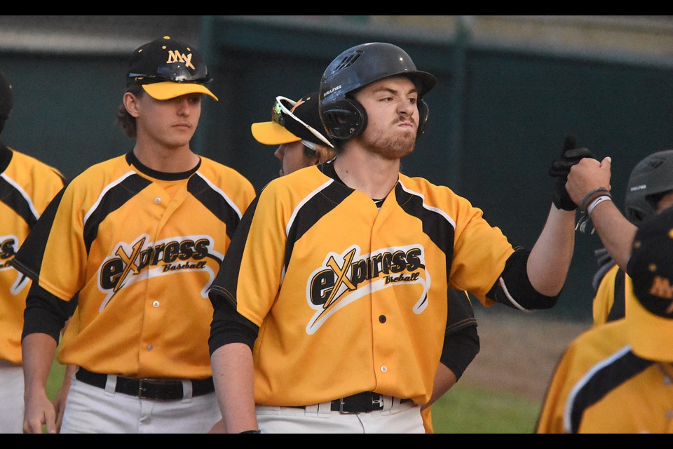 Express hitter Michael Borst celebrates with teammates after his sacrifice fly scored the second run of the game.