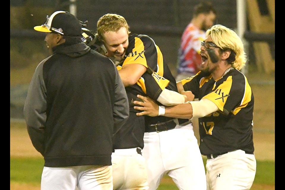 Miller Express pitcher Westin Walls celebrates with teammates after getting the final out in Game 2.