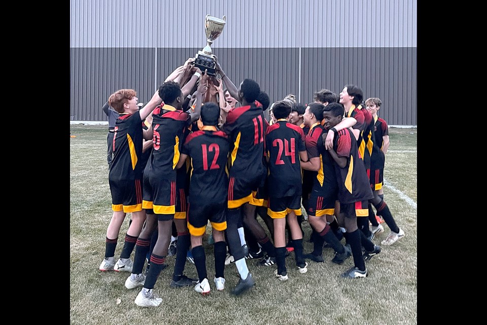 The Central Cyclones celebrate with the trophy after winning the MJHSAA league championship.