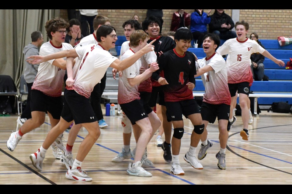 The Vanier Vikings celebrate after winning the 4A boys volleyball provincial bronze medal.