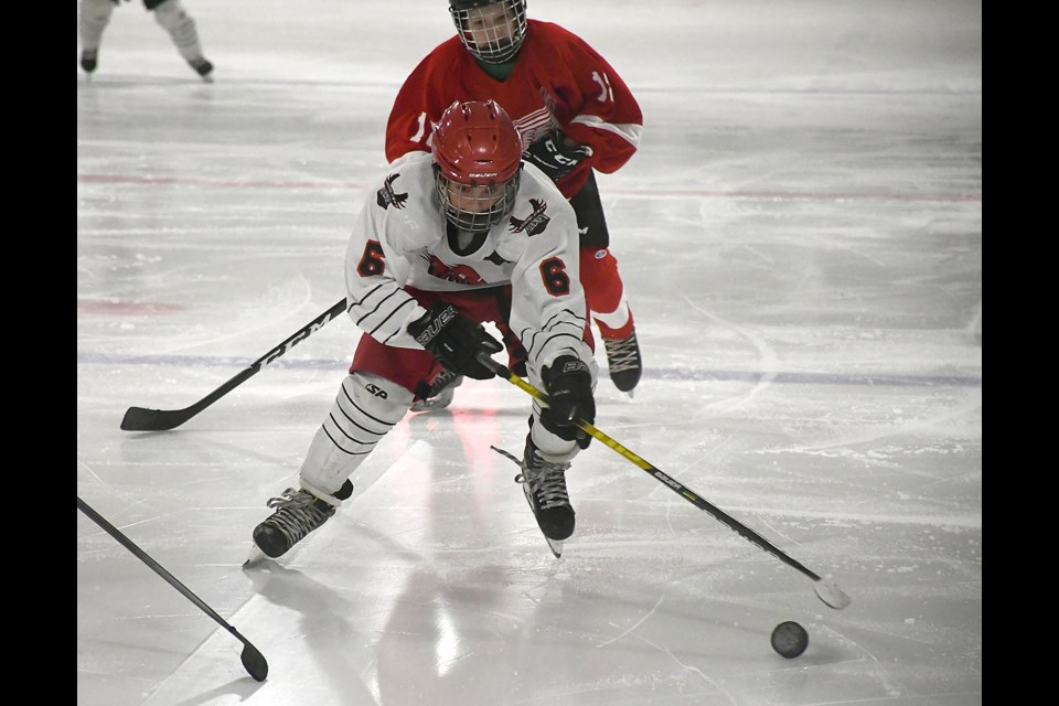 U13 AA Warriors forward Ryder Gilroy breaks into the Weyburn zone.