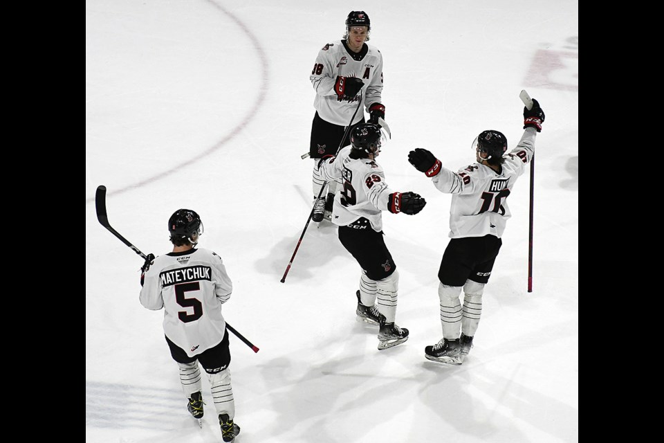 Brayden Yager (centre) and the Warriors celebrate after Yager's game-winning goal.