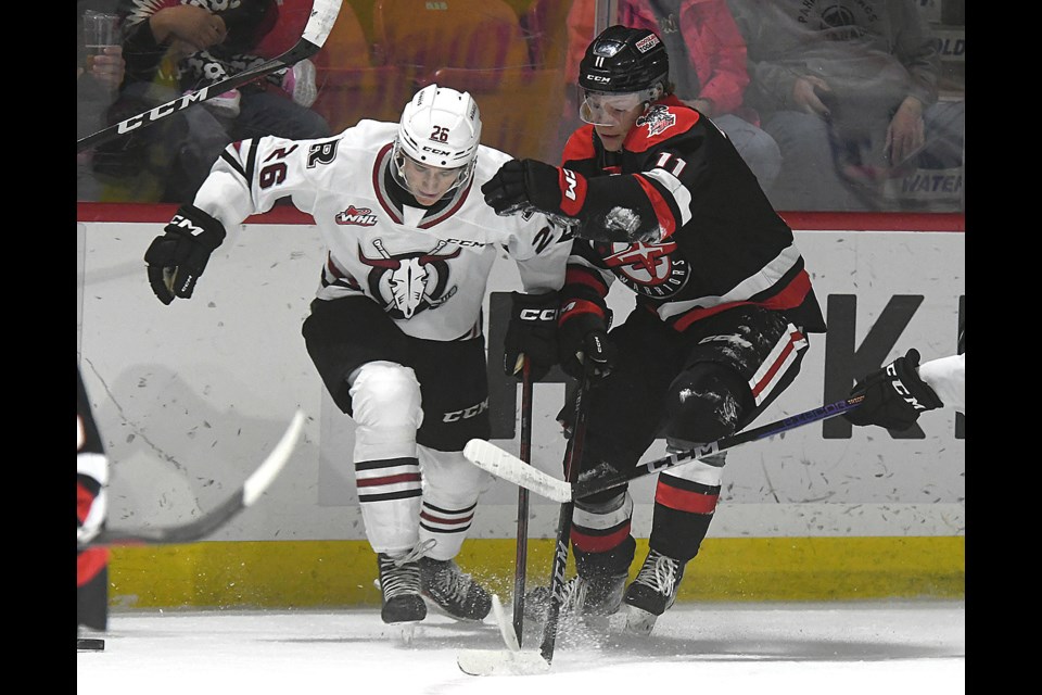 Warriors forward Harper Lolacher battles a Red Deer defender during third period action. 