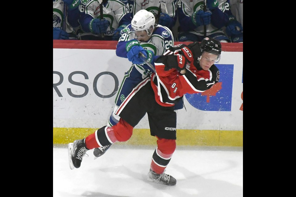 Harper Lolacher of the Moose Jaw Warriors lays a hit on Swift Current’s Van Eger during a game last season in Swift Current. Eger has been traded to the Prince George Cougars.