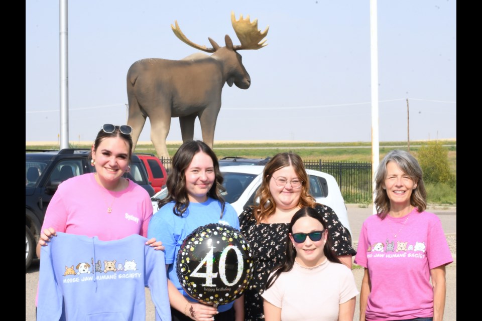 Mac the Moose was celebrated throughout the day on Aug. 16 with summer events co-ordinators Sydney Woodrow (left) and Paige McClinton (second from left) representing Tourism Moose Jaw at the event.