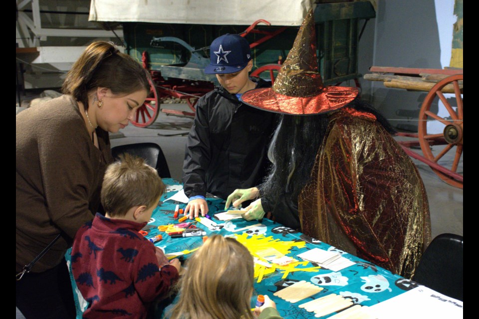 Guests make scarecrow-themed crafts during “Halloween Hurrah” at the WDM.