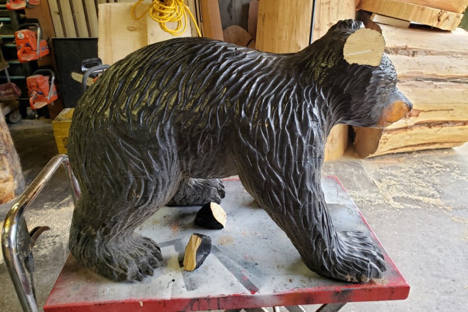 baby black bear carving damaged