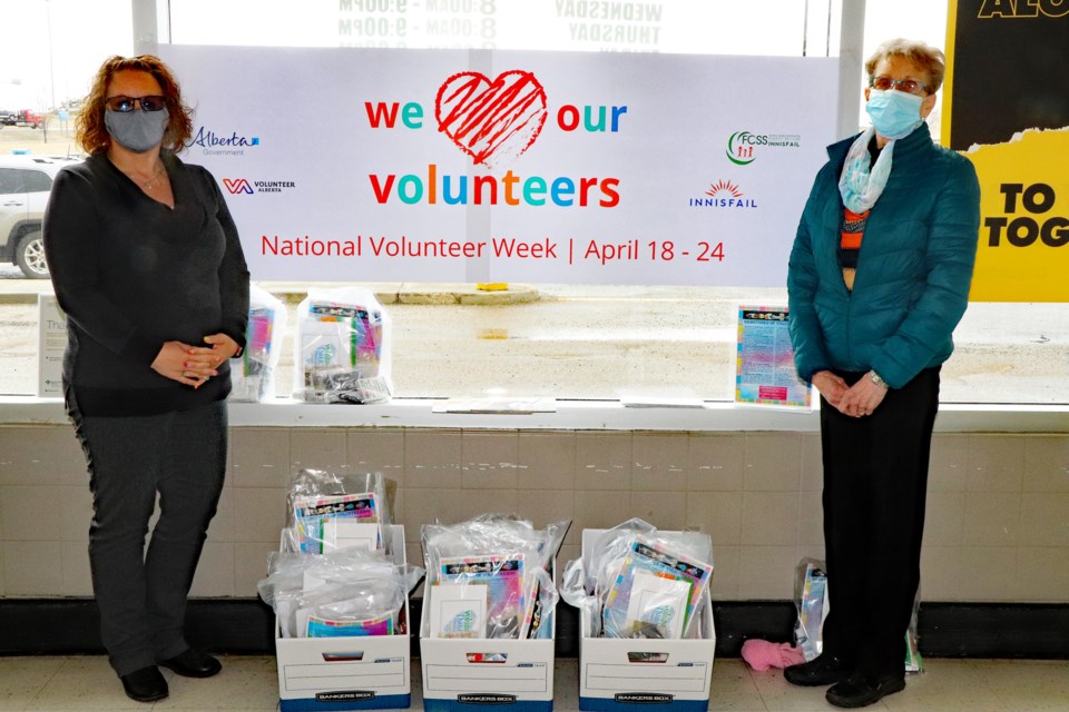 Sandy Wacker, the town's community supports and age friendly coordinator, left, and volunteer Dianne Mainville at Innisfail's No Frills grocery store to offer thanks and gift bags to volunteering citizens on National Volunteer Week. Johnnie Bachusky/MVP Staff