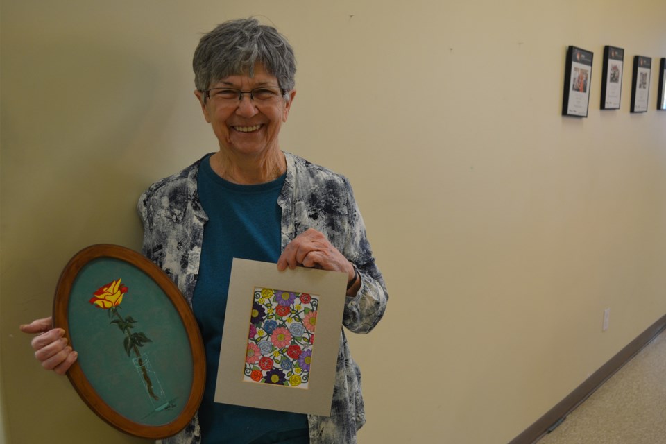 Doris Fay, one of two featured artists for the Olds Art Club's spring show and sale, displays a couple of her works.
Doug Collie/MVP Staff