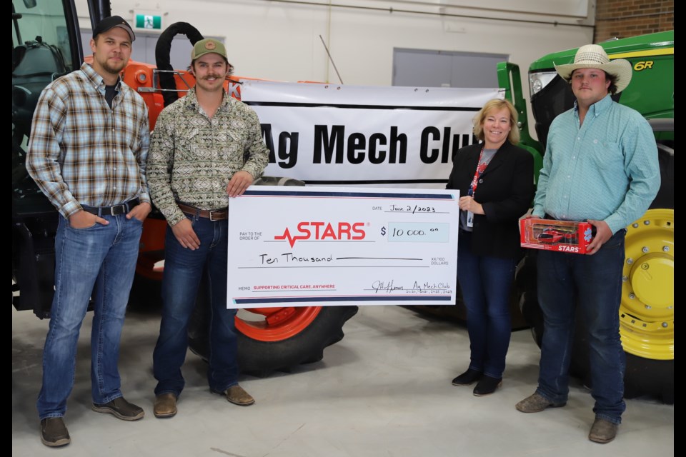 From left, Olds College Ag Mech Club president Carter Kittlitz and club vice-president Greg Mulhall present a cheque for $10,000 to STARS Air Ambulance rep Meagin Huisman. Looking on is Ag Mech vice-president Travis Chessor.