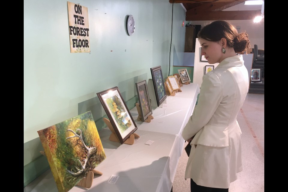 FIRST TIME AT SUNDRE ART SHOW – Celine Lockie, from Olds, was among 15 local and regional artists who featured their work at the Sundre Creative Arts Group's annual art show and sale at the Sundre West Country Centre over the past weekend. It was her first time exhibiting at the show in Sundre, and she also enjoyed the opportunity to see the variety of other styles that were on display. Simon Ducatel/MVP Staff