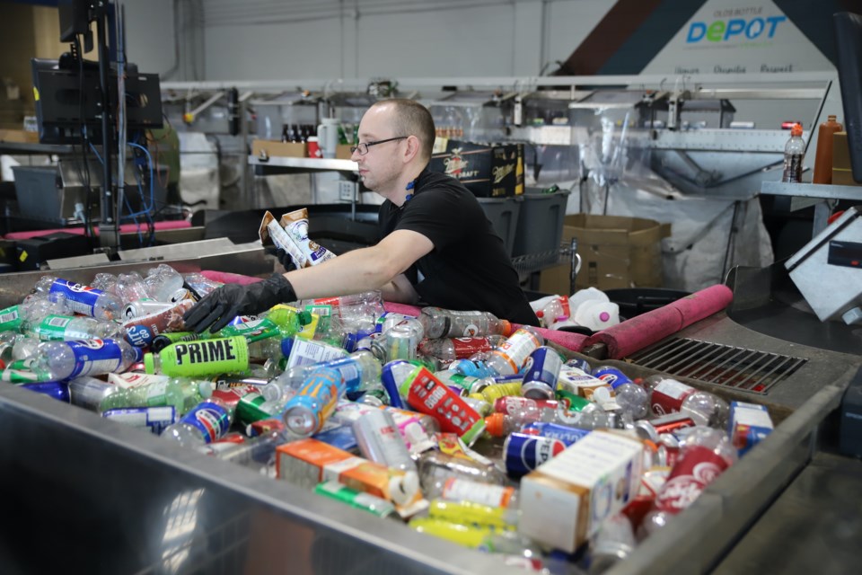 An employee sorts containers dropped off.
Doug Collie/MVP Staff