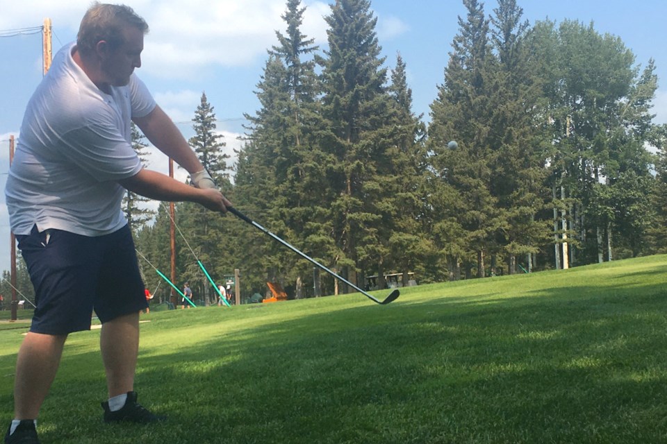 Eric Belt, from Calgary, successfully chips Aug. 3 onto the green on hole 18 at the Sundre Golf Club during a friendly game of best ball that was part of an inaugural fundraising tournament organized by non-profit group Burden Bearers Counselling, which provides services throughout both Clearwater and Mountain View counties to everyone regardless of their financial situation. 
Simon Ducatel/MVP Staff