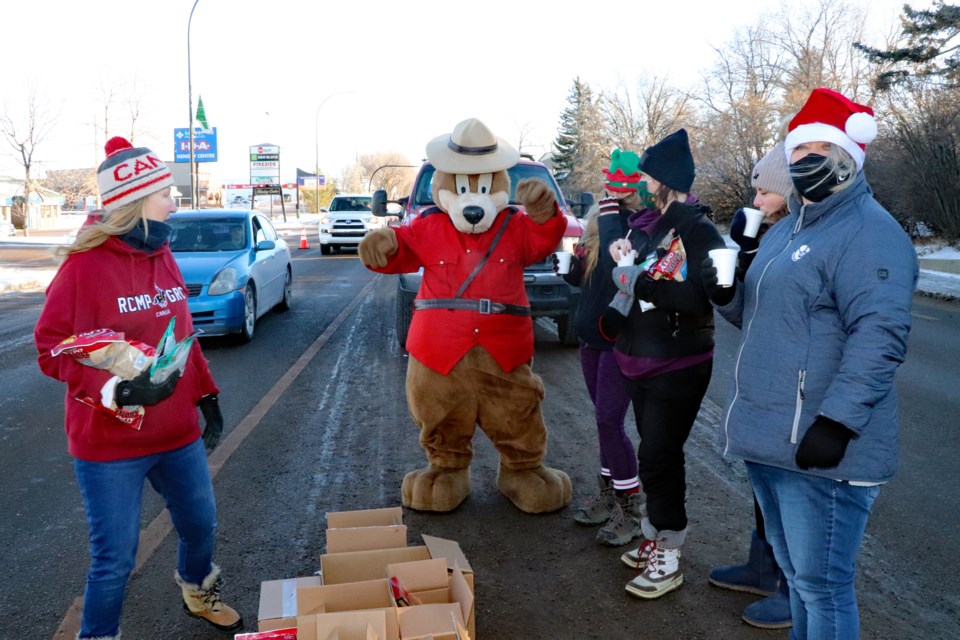 The RCMP Safety Bear does a dance shuffle for volunteers helping out at the 25th Annual Charity Check Stop along Main Street on Dec. 11. The event raised a record sum of cash to help the less fortunate in the community. 
Johnnie Bachusky/MVP Staff