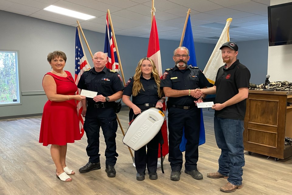 Two Innisfail service clubs officially donated money to the Innisfail Fire Department on May 11 towards the $19,000 cost of a lifesaving LUCAS chest compression unit. From left to right is Tammy Thompson, past-president of the Rotary Club of Innisfail, Gary Leith, fire chief of the Innisfail Fire Department, firefighter Kayla Ainscough; Tim Ainscough, assistant fire chief and Sanjay Davis, president of the Innisfail Kinsmen. Johnnie Bachusky/MVP Staff