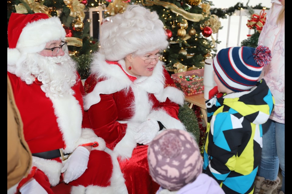 Santa and Mrs. Claus chat with Rylee Smith, 2; and her brother Bodie, 5, during the Christmas kickoff.
Doug Collie/MVP Staff