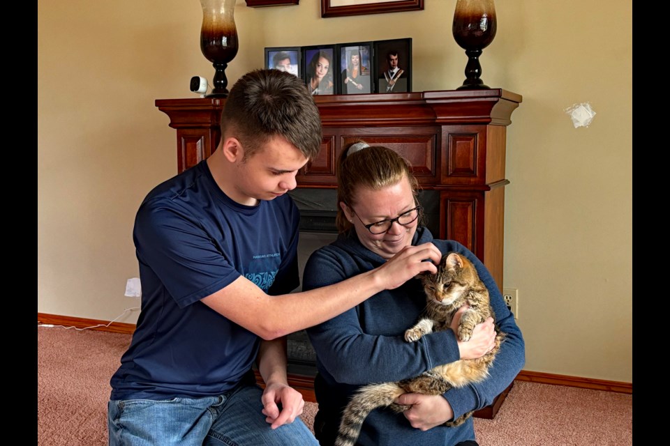 Kenneth Griffith with his mother Sheri and long-time feline friend Cookie, who is dying of cancer. The family has created a legacy fund in Cookie's name to help financially challenged families who need support during their pet's palliative care process. Johnnie Bachusky/MVP Staff