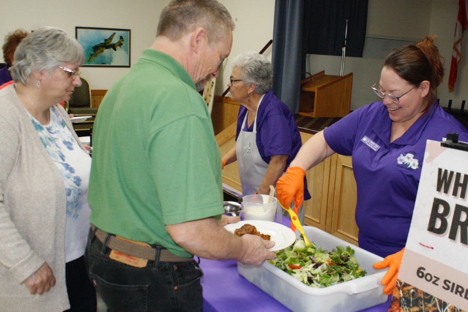 Marlene Waddell, background left, a community volunteer and former longtime member of Sundre Royal Purple, and Sharon Flett, a member of the Sundre Royal Purple #191 as well as the Alberta Royal Purple director of marketing and membership, served approximately two dozen people who came out to the local legion on Wednesday, Nov. 20 for the monthly Cooking for Kindness luncheon.
Simon Ducatel/MVP Staff