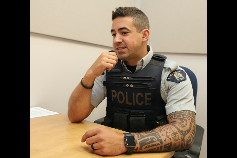 Cst. Mitch Price in a thoughtful mood during an interview with the Albertan.