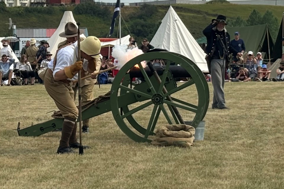 Members of the Yankee Valley Yankees light a 12-pound mountain howitzer during the festival. The group is focused on bringing to life the American Civil War.
