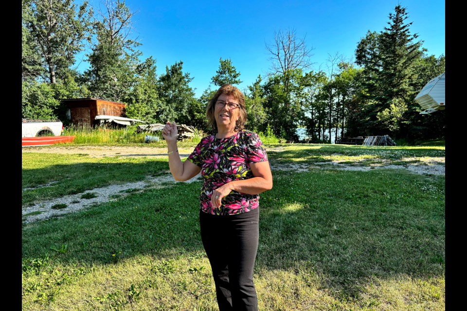 Laurie Miller at her vacant property at 5140 – 56th Street. She and her husband Randy have owned it since 1986, and once lived on it for 19 years in their own house before building a new home on property immediately east. Johnnie Bachusky/MVP Staff  