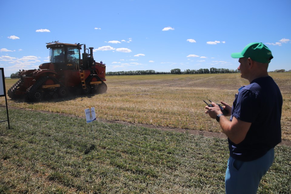 A drone is launched as the tractor begins its route in a  field.
Doug Collie/MVP Staff