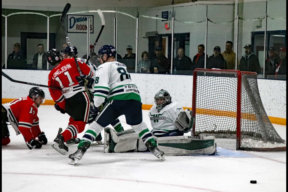 The puck slips loose near the Wetaskiwin crease during intense second period action of Game 4 in the NCHL semifinal series on March 2 at the Innisfail Twin Arena. The Innisfail Eagles defeated the Wetaskiwin Longhorns 4-1 to win the series three games to one. Johnnie Bachusky/MVP Staff