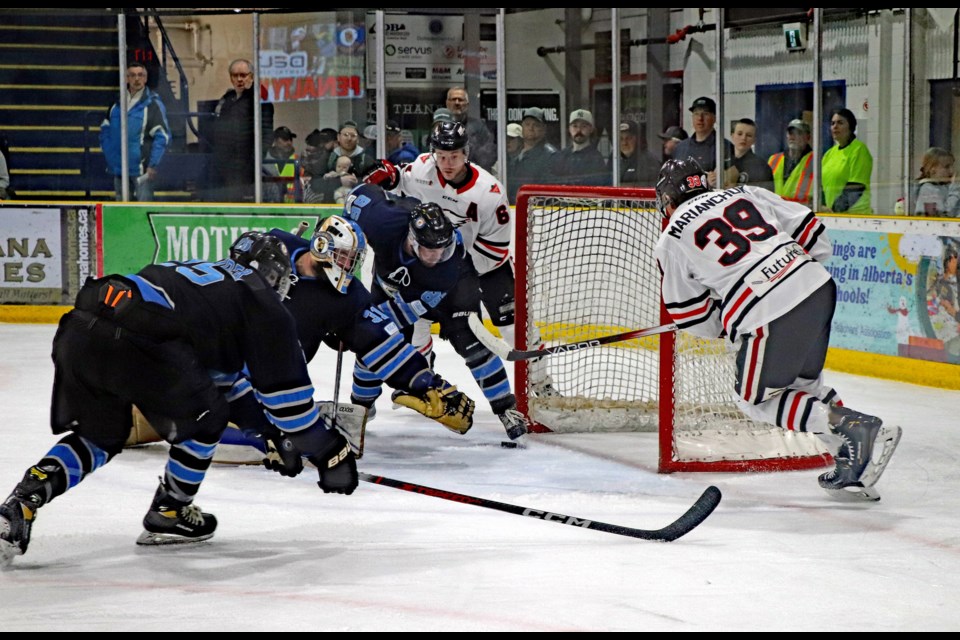 In the second period of Game 3 of the North Central Hockey League finals on March 16 the Innisfail Eagles pressed hard at the Lacombe Generals' net and had a puck slide through the home team's crease and nearly score.
 Johnnie Bachusky/MVP Staff